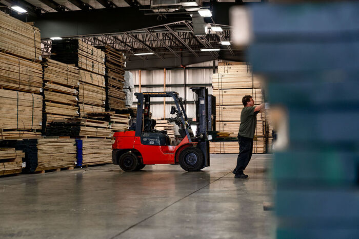 Craftsmen Forklift for wooden products in the large warehouse